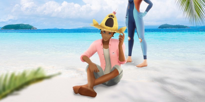 A Pokémon Go character sits on the beach with a Sandygast hat atop their head