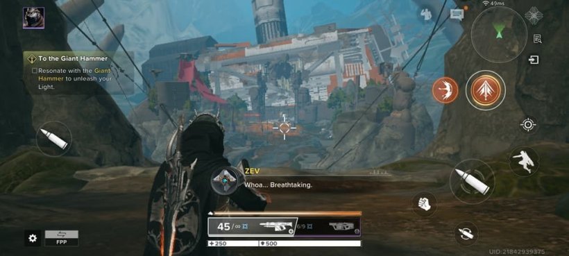 A wolf-armoured man with an assault rifle looks over a towering building in the shape of a hammer.