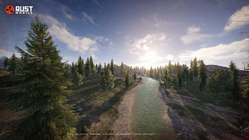 An image of a wide open forest with a setting sun and blue river cutting through it.
