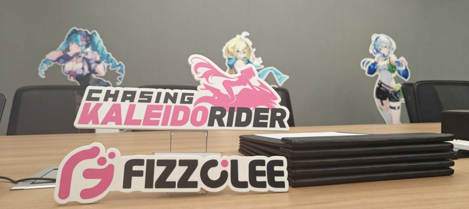 chasing kaleidorider standees in a conference room