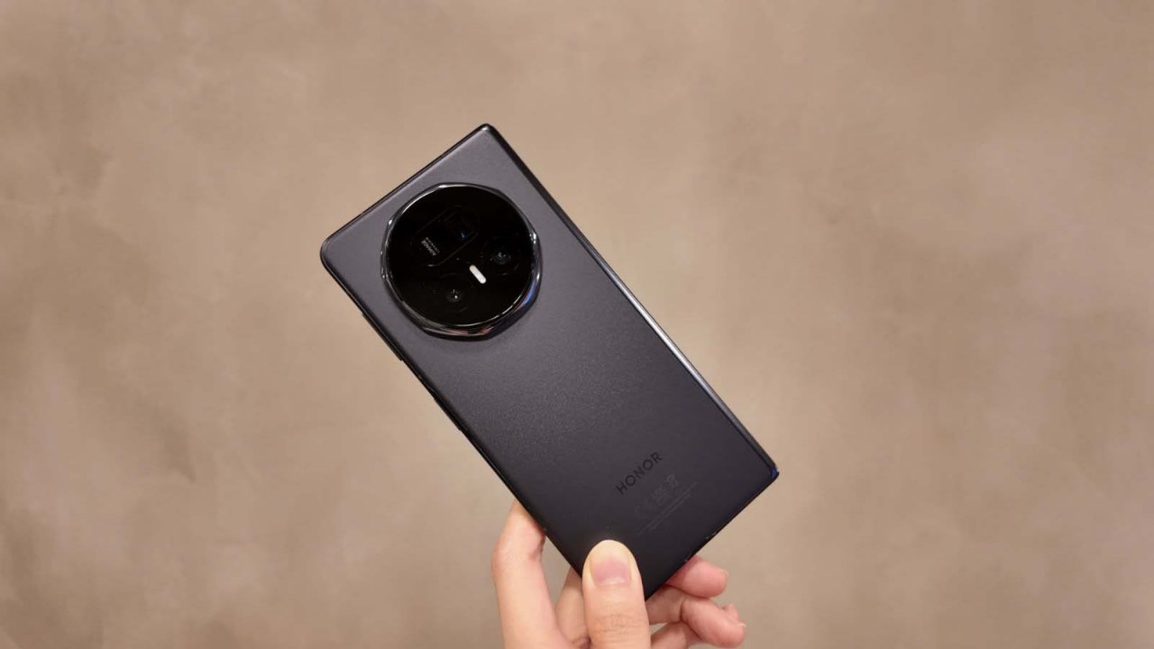 v5 foldable smartphone held up against a concrete wall