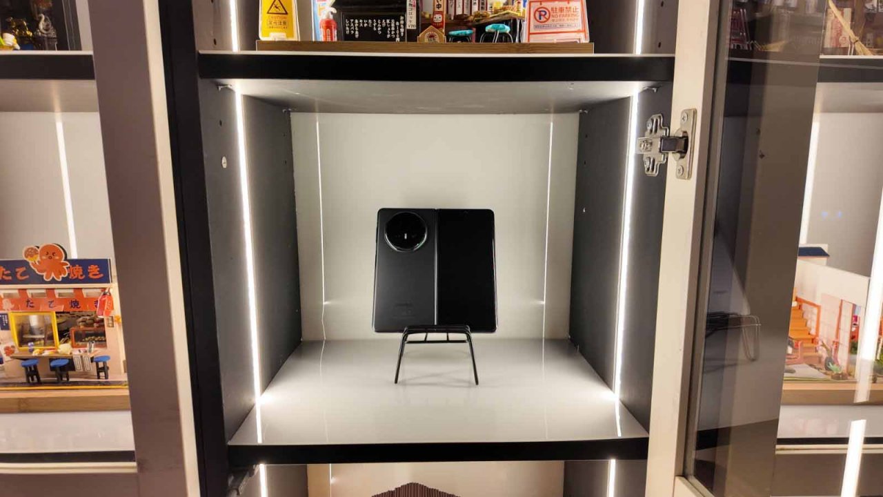 the v5 propped up on a stand to show the back cover and the outer screen