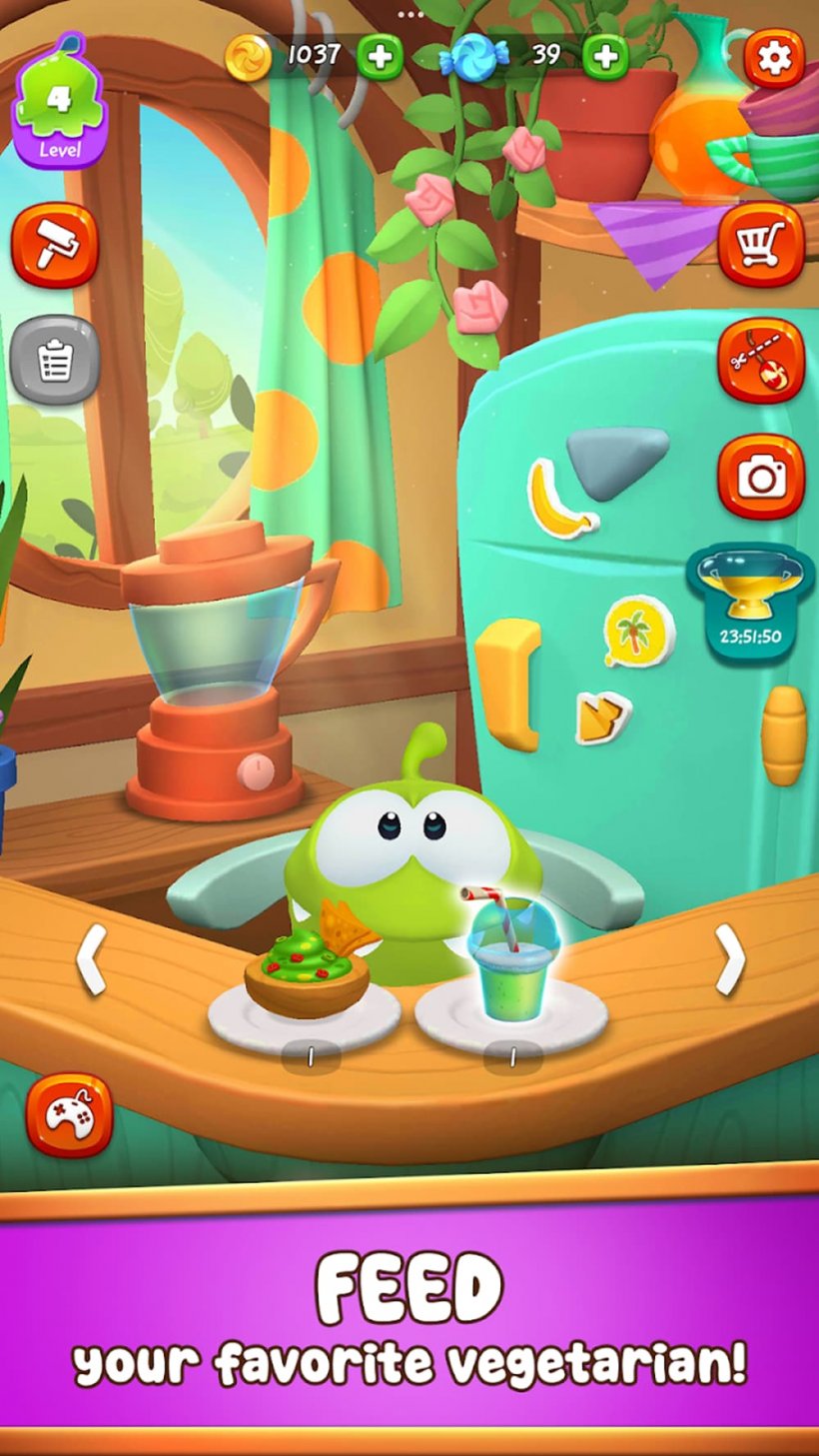 A cute green creature sits in a high-chair being feed snacks.