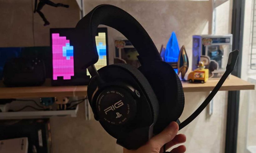 the rig r5 headset held up against a dark background with led lights