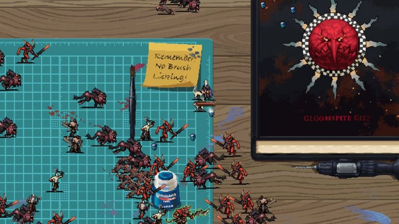 Characters from the Warhammer 40,000 universe do battle on a hobby table, complete with cutting mat for painting and making miniatures.