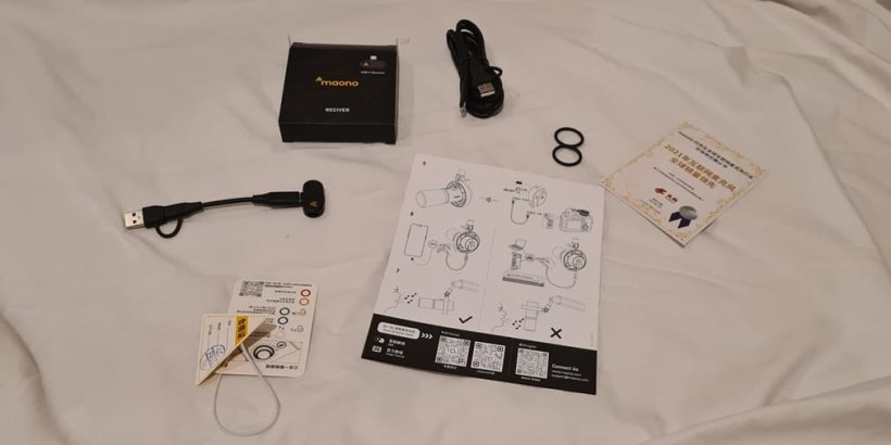 A picture of a number of accessories laid out including a USB cable, manual and other items.