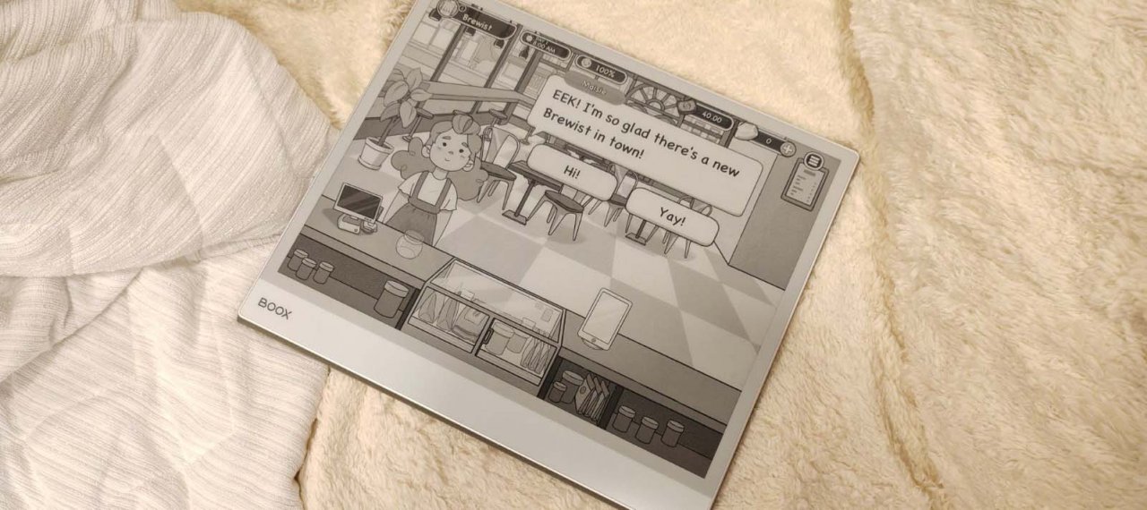 a black and white screen with a barista on a tablet on a couch