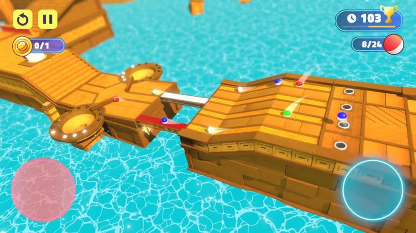 Balls travel along a large stone brige above blue water.