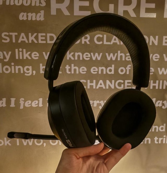 a headset held up against a wall with a wall quote