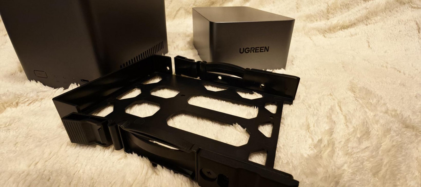 a hard drive tray set on a surface with no screws