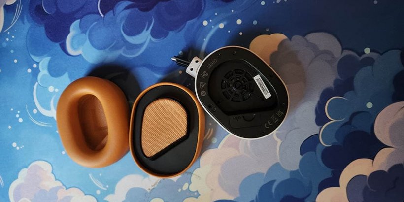 front and back views of orange ear pad next to ear housing