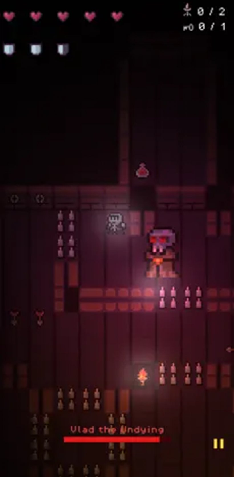 A screenshot of a skull-headed creature stalking a person through dark tunnels with only the light of a torch.