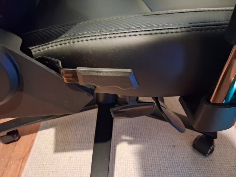 The adjustment controls for a large black gaming chair, with a large chunky handle boasting an impressive moulded grip.