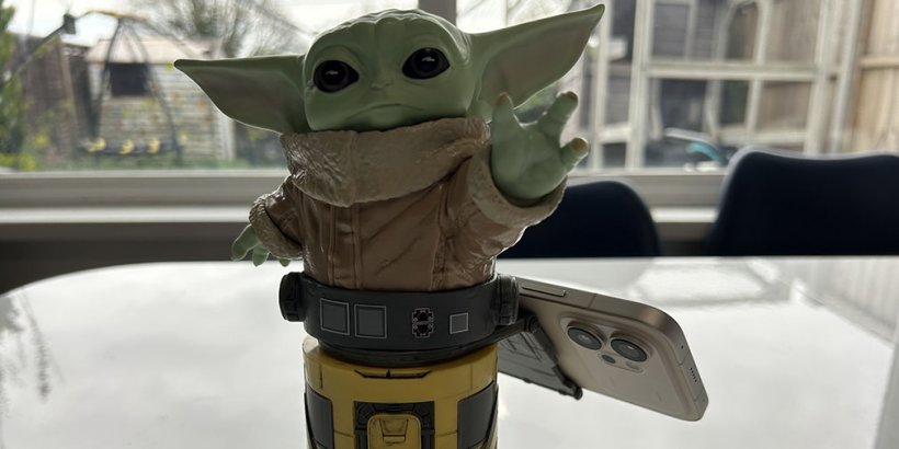 Phone on the back of a Grogu Cable Guys